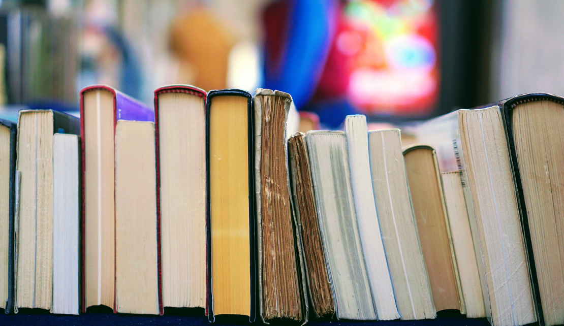 a row of worn books on their side